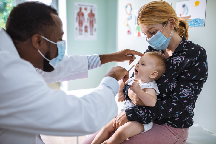 Doctor giving a baby an immunization. Doctor giving a baby an immunization.